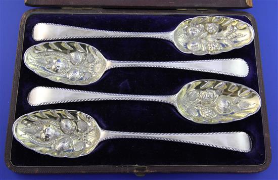 A cased set of four George II silver table spoons later decorated as berry spoons with gilded bowls, 8 oz.